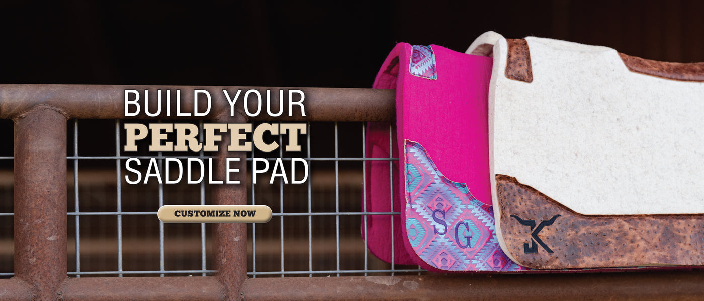 Custom pink and cream saddle pads displayed on a metal fence with “Build Your Perfect Saddle Pad” promotion.