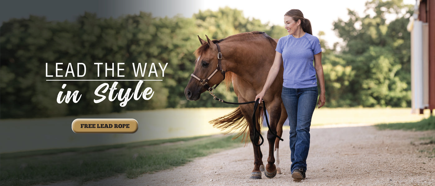 Woman walking a chestnut horse on a lead rope along a barn path with promotional text reading “Lead the Way in Style” and “Free Lead Rope.”